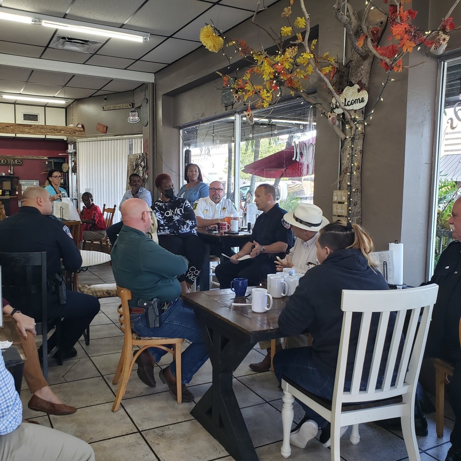 Community members gather at Common Grounds Coffee Shop in Clewiston for the first "Coffee with the Chief" event Sept. 22. Clewiston Interim Police Chief Thomas Lewis explains how the department works and answered questions. The event was coordinated by the Clewiston Chamber of Commerce.